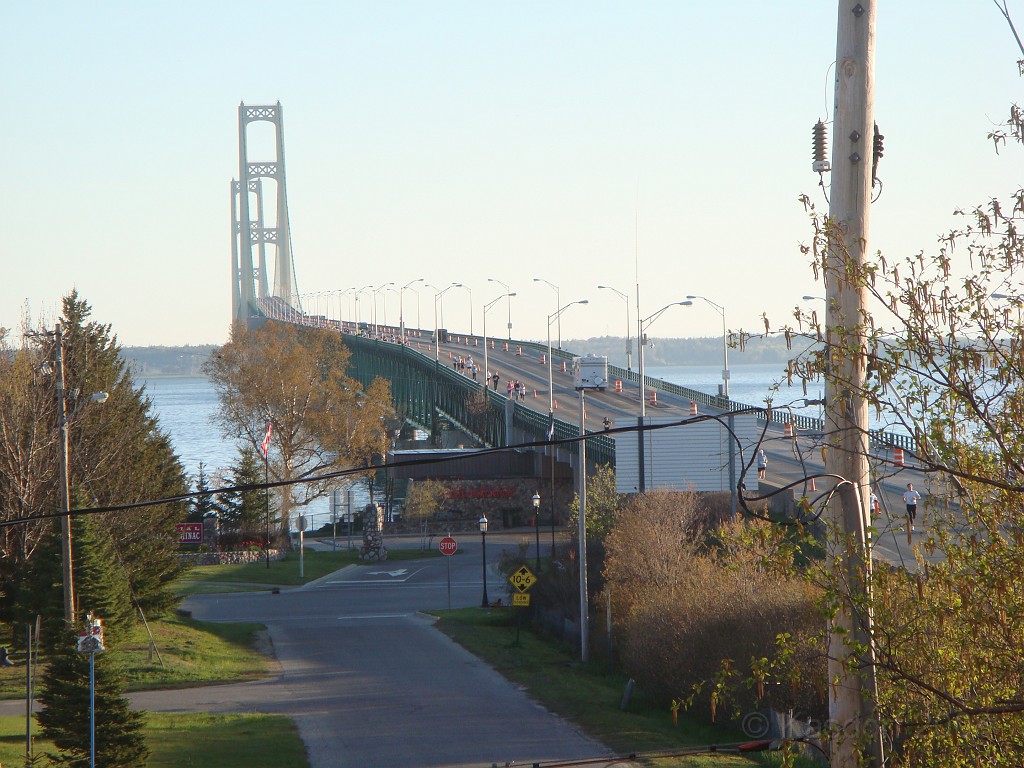 Mackinaw Bridge Race 2008-05 0208.jpg - The view of the bridge from the hotel room. You can see the runners that are still on the bridge. This is after I finished, cooled down, walked back to car, drove to hotel and climbed to third floor. Not that I am so fast.... I just started so early!